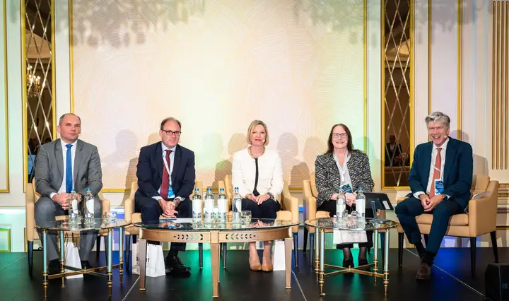 A five-person panel seated on stage