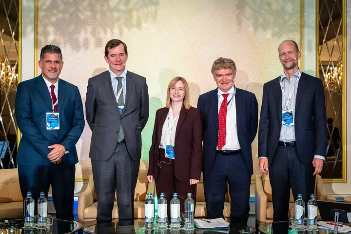 Five speakers on stage after a panel